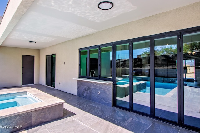 view of pool featuring an in ground hot tub, a patio area, and a fenced in pool
