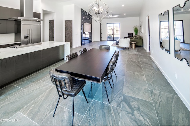 dining space with an inviting chandelier and baseboards