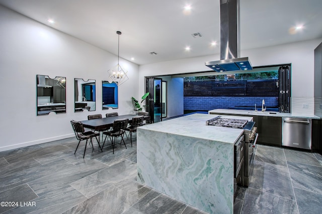 kitchen featuring visible vents, island range hood, modern cabinets, appliances with stainless steel finishes, and a chandelier