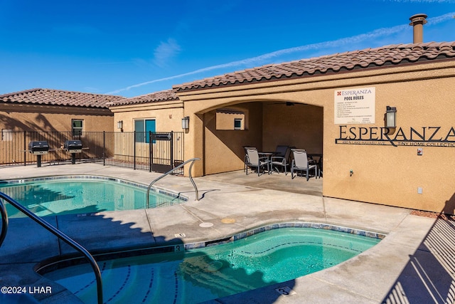 view of swimming pool featuring area for grilling, a patio area, and a hot tub