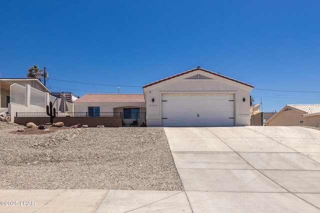 2764 Daytona Ave, Lake Havasu City, AZ 86403 - ranch-style home featuring a tile roof, fence private yard, a garage, concrete driveway, and stucco siding
