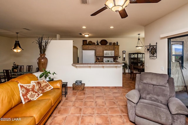 living room featuring light tile patterned floors, a ceiling fan, and recessed lighting