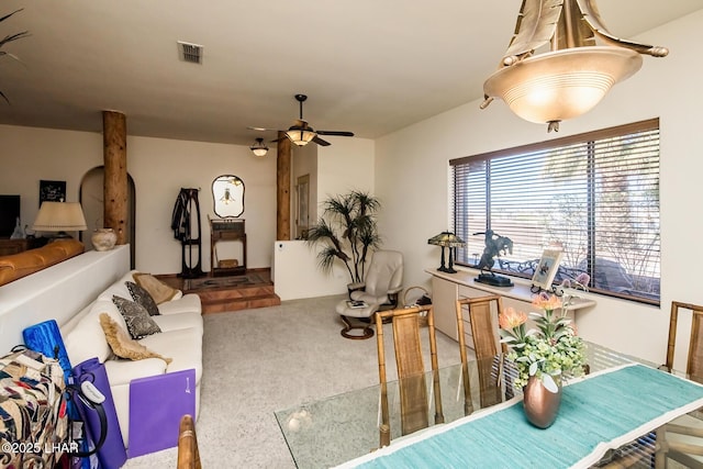 carpeted living room with visible vents and ceiling fan