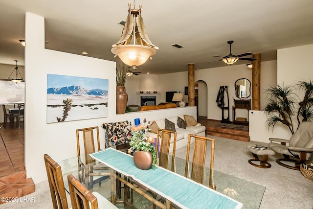 dining area featuring arched walkways, visible vents, and a ceiling fan