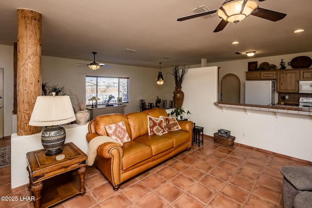 living room with ceiling fan and light tile patterned floors