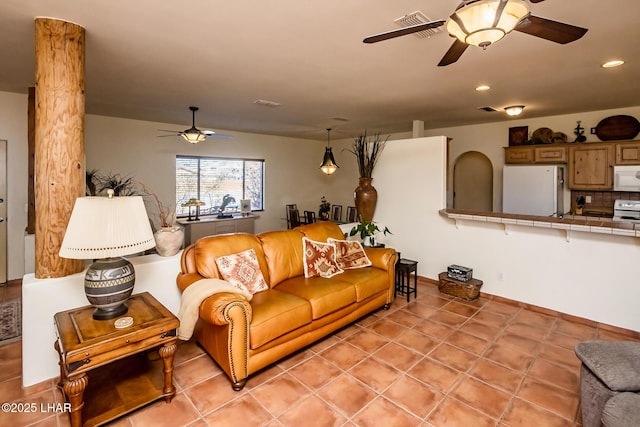 living area featuring recessed lighting, light tile patterned floors, visible vents, and ceiling fan