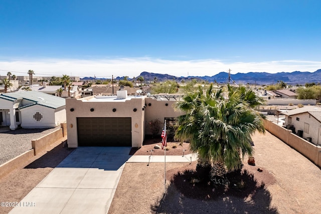 southwest-style home featuring a mountain view and a garage