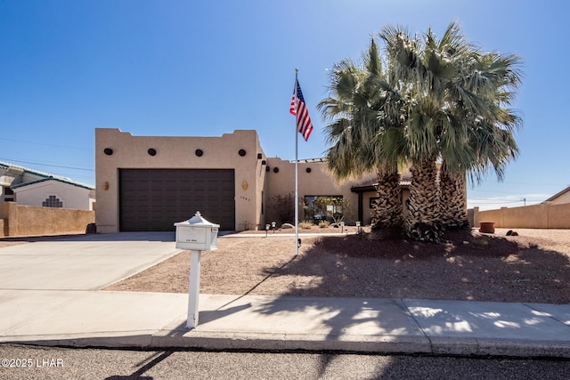 pueblo revival-style home with a garage