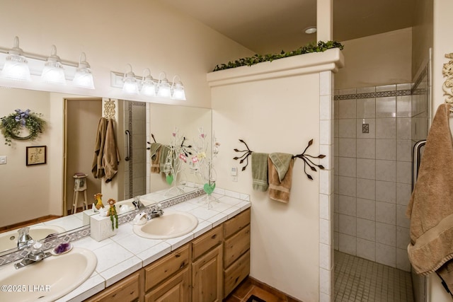 bathroom featuring vanity and tiled shower