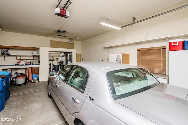 garage with visible vents and a garage door opener