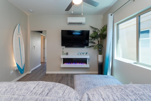 490 N Lake Havasu Ave Unit J, Lake Havasu City, AZ 86403 - bedroom featuring a wall mounted air conditioner, multiple windows, wood finished floors, and baseboards