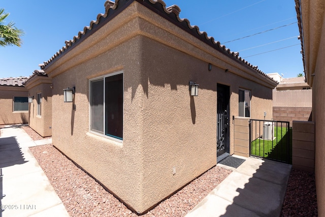 490 N Lake Havasu Ave Unit J, Lake Havasu City, AZ 86403 - view of side of home featuring stucco siding and a tiled roof