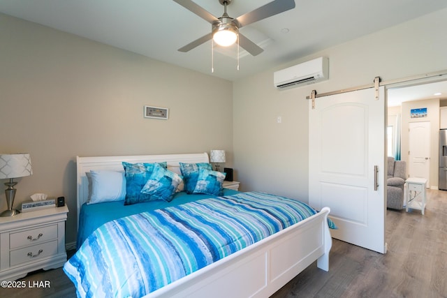 490 N Lake Havasu Ave Unit J, Lake Havasu City, AZ 86403 - bedroom with an AC wall unit, a barn door, wood finished floors, stainless steel fridge with ice dispenser, and a ceiling fan