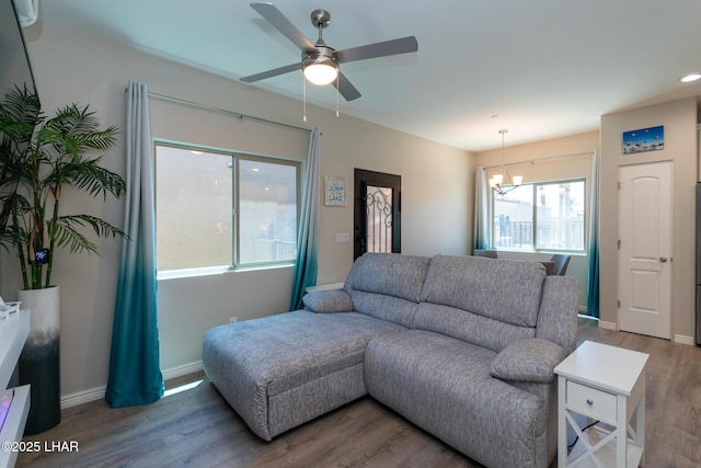 490 N Lake Havasu Ave Unit J, Lake Havasu City, AZ 86403 - living room featuring a ceiling fan, a chandelier, wood finished floors, and baseboards