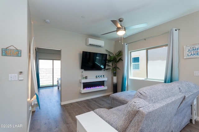 490 N Lake Havasu Ave Unit J, Lake Havasu City, AZ 86403 - living room featuring a wall mounted AC, plenty of natural light, a ceiling fan, and wood finished floors