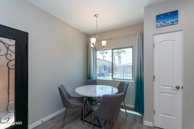 490 N Lake Havasu Ave Unit J, Lake Havasu City, AZ 86403 - dining area with wood finished floors, a chandelier, and baseboards