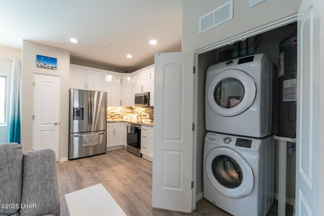 490 N Lake Havasu Ave Unit J, Lake Havasu City, AZ 86403 - clothes washing area with estacked washer and dryer, recessed lighting, and light wood finished floors