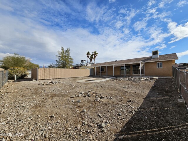 back of property with a patio