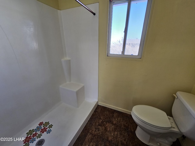 bathroom with walk in shower and toilet