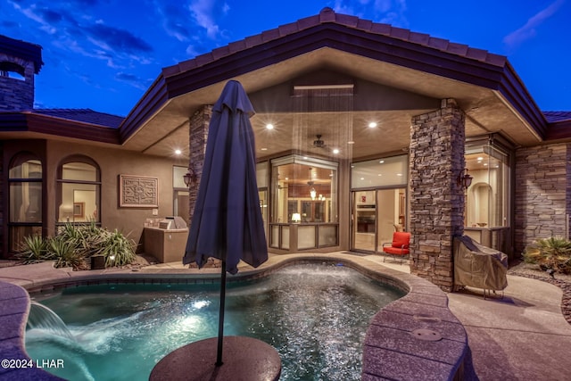 pool at dusk with a patio