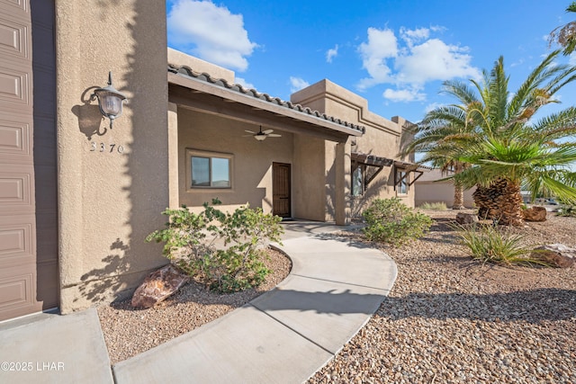 3370 Thunderhead Dr, Lake Havasu City, AZ 86406 - view of exterior entry featuring stucco siding, a ceiling fan, and a tile roof