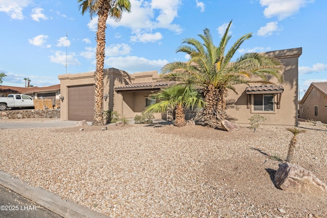 3370 Thunderhead Dr, Lake Havasu City, AZ 86406 - view of front of home featuring an attached garage, concrete driveway, stucco siding, and a tiled roof