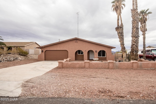 view of front of house featuring stucco siding, a garage, and concrete driveway