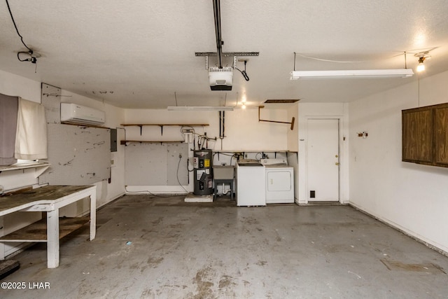 garage with an AC wall unit, a garage door opener, separate washer and dryer, and electric water heater