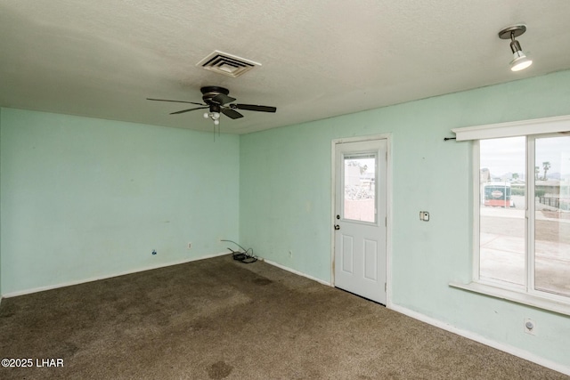 interior space featuring visible vents, a textured ceiling, and ceiling fan