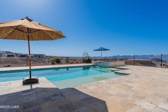 view of pool featuring a patio, a pool with connected hot tub, and fence