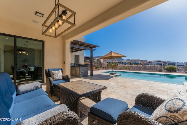 view of pool featuring a patio, fence, exterior kitchen, outdoor lounge area, and a fenced in pool