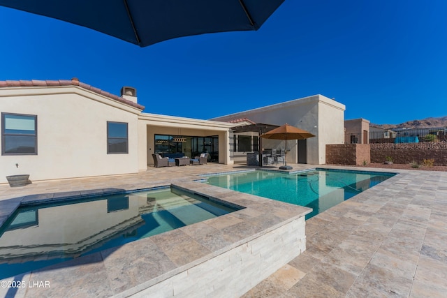 view of pool featuring a fenced in pool, fence, an outdoor living space, an in ground hot tub, and a patio area