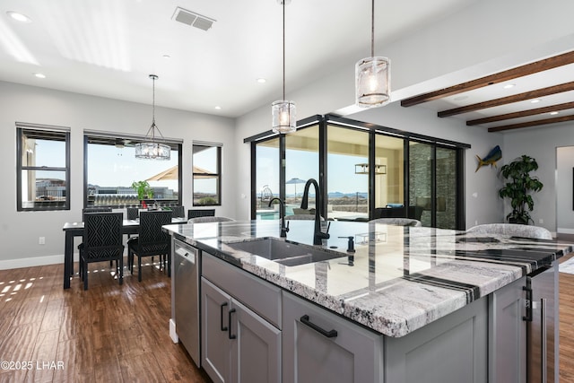 kitchen with a sink, dark wood-type flooring, gray cabinetry, and dishwasher