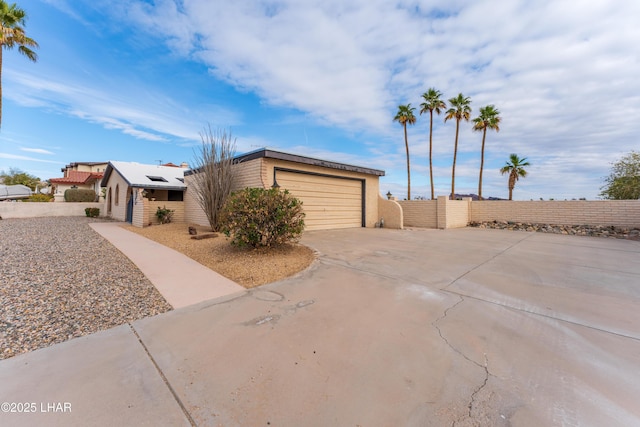 view of home's exterior with a garage and solar panels