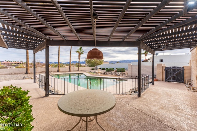 view of swimming pool featuring a pergola, a patio area, and a mountain view