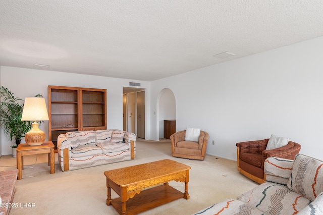 carpeted living room with a textured ceiling