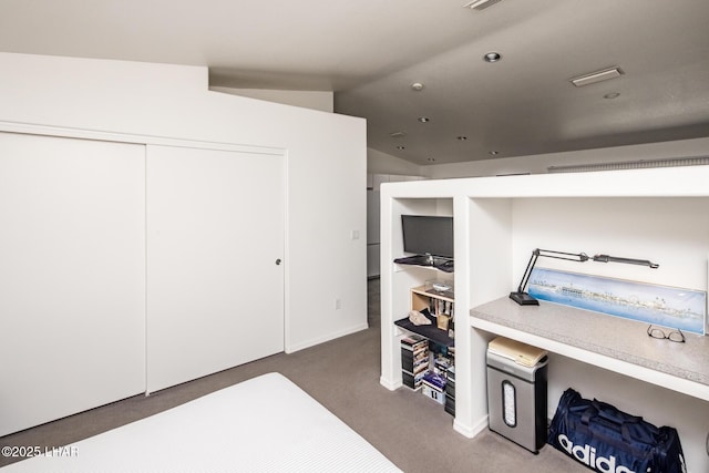 carpeted office with lofted ceiling and visible vents