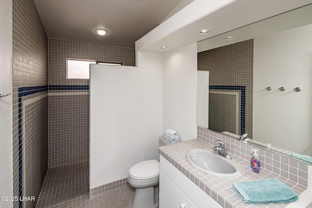 full bathroom featuring tile patterned floors, vanity, toilet, and walk in shower