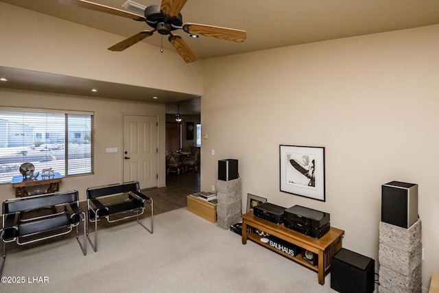 living room with carpet floors and ceiling fan