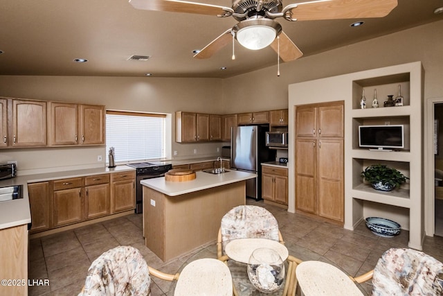 kitchen with ceiling fan, stainless steel appliances, a sink, visible vents, and light countertops