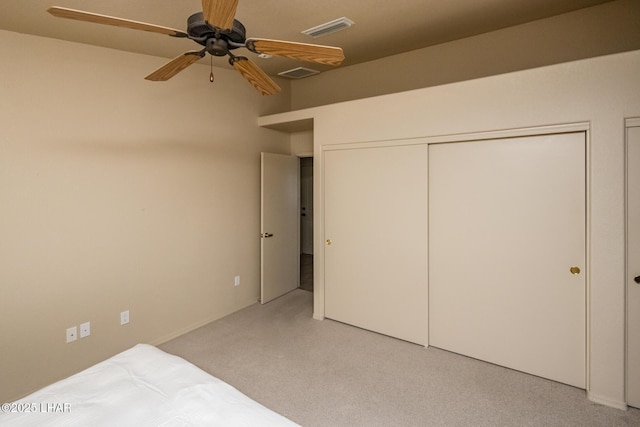 unfurnished bedroom featuring visible vents, ceiling fan, and light carpet