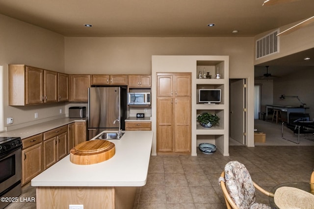 kitchen featuring appliances with stainless steel finishes, light countertops, visible vents, and a sink