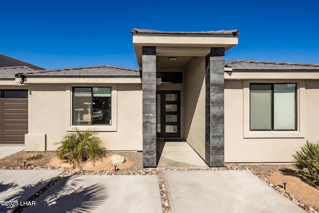 doorway to property with a garage