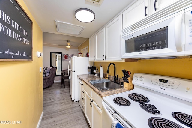2100 Swanson Ave Unit 201, Lake Havasu City, AZ 86403 - kitchen with white appliances, a sink, white cabinetry, light wood-type flooring, and baseboards