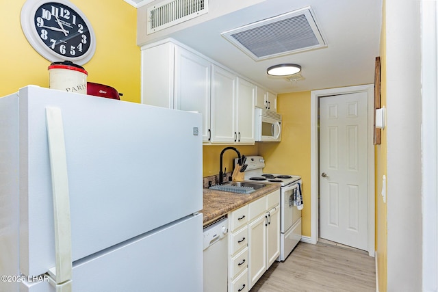 2100 Swanson Ave Unit 201, Lake Havasu City, AZ 86403 - kitchen with white appliances, white cabinetry, light wood-style flooring, a sink, and baseboards