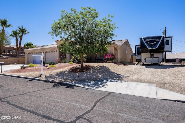 2554 Beverly Glen Dr, Lake Havasu City, AZ 86403 - view of front of home featuring concrete driveway, an attached garage, and stucco siding