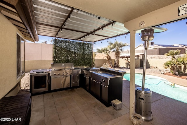 view of patio / terrace with area for grilling, a fenced backyard, a fenced in pool, and a grill