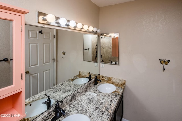 bathroom featuring a sink and double vanity