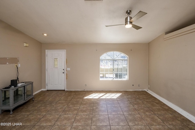 foyer entrance with lofted ceiling, tile patterned flooring, baseboards, and ceiling fan