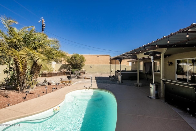 view of swimming pool featuring a patio area, a hot tub, a fenced in pool, and a fenced backyard